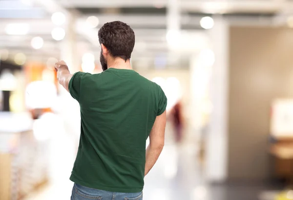 young man back pointing front