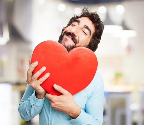 Happy young man with heart shape — Stock Photo, Image