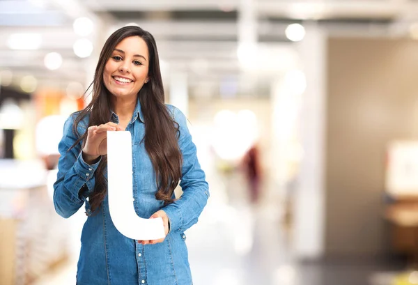 Happy young woman with letter j — Stock Photo, Image