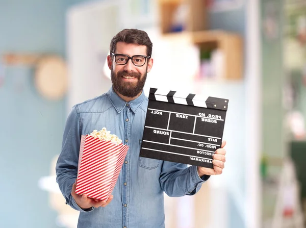 Happy young man with clapper — Stock Photo, Image
