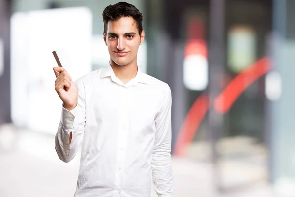 Happy young man with credit card — Stock Photo, Image