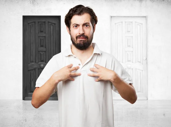 Surprised young man in confused pose — Stock Photo, Image