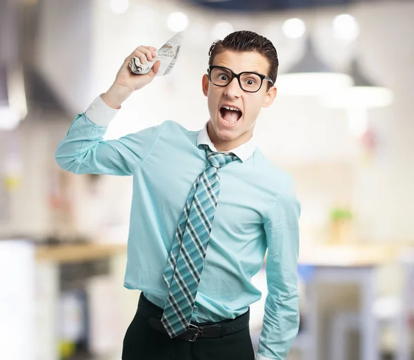 Angry businessman with newspaper — Stock Photo, Image