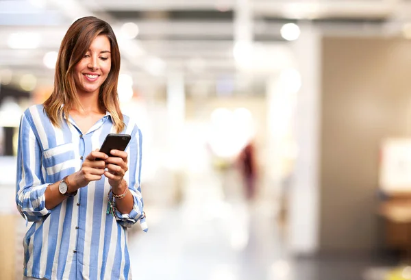 Happy young woman with mobile phone — Stock Photo, Image