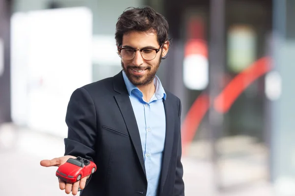 Indian businessman with red toy car — Stock Photo, Image