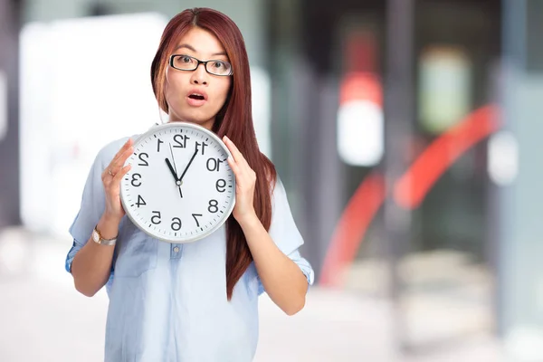 worried chinese woman with clock