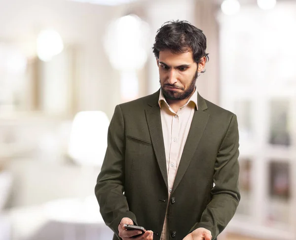 confused businessman with mobile phone