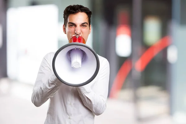 Young man shouting with megaphone — Stock Photo, Image