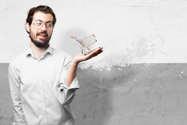 Happy young man with shopping cart — Stock Photo, Image