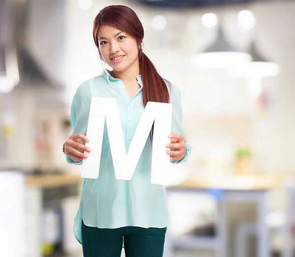 Happy chinese woman with m letter — Stock Photo, Image