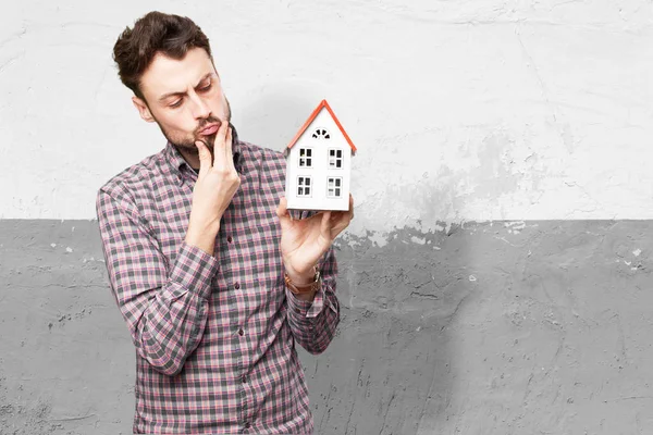 Young man with house thinking — Stock Photo, Image