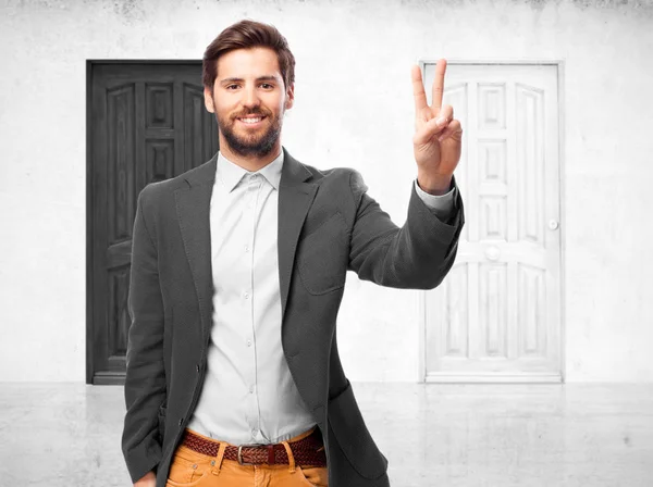 Happy businessman with victory gesture — Stock Photo, Image