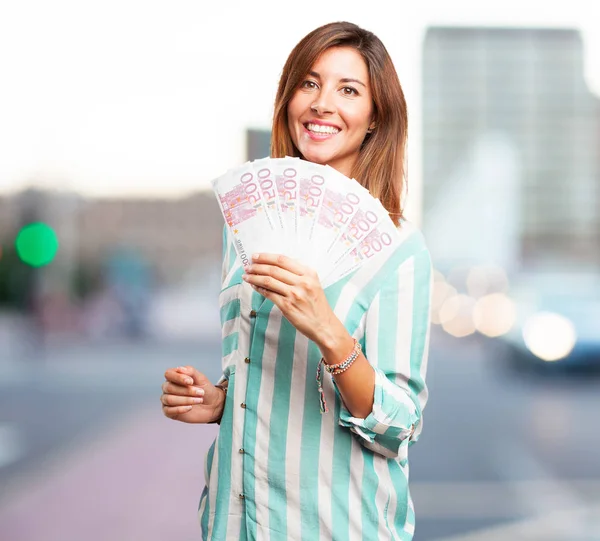 Happy young woman with bills — Stock Photo, Image