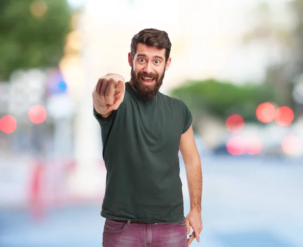 Happy young man pointing front — Stock Photo, Image