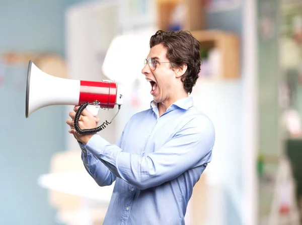 Angry young man s megafon — Stock fotografie