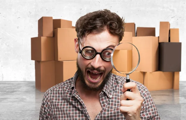 Crazy young man with magnifying glass — Stock Photo, Image