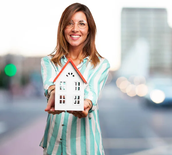 happy young woman with house