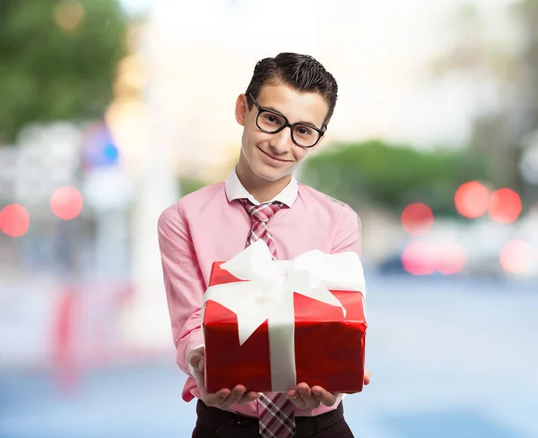 Happy businessman with gift — Stock Photo, Image