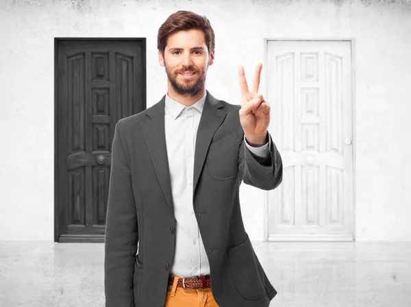 Happy businessman with victory gesture — Stock Photo, Image