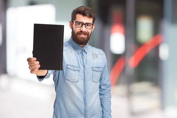 Joven feliz con libro pequeño —  Fotos de Stock