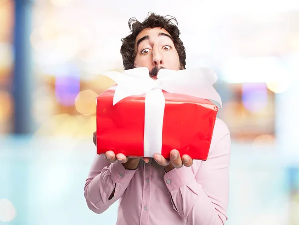 Happy young man with gift — Stock Photo, Image