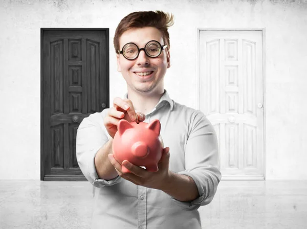 Crazy young man with piggy bank — Stock Photo, Image