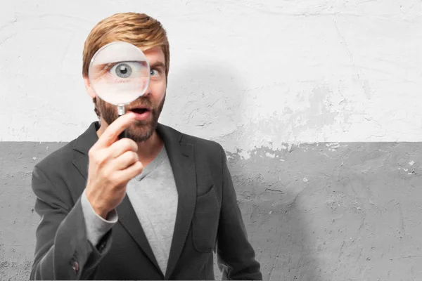 Surprised businessman with magnifying glass — Stock Photo, Image