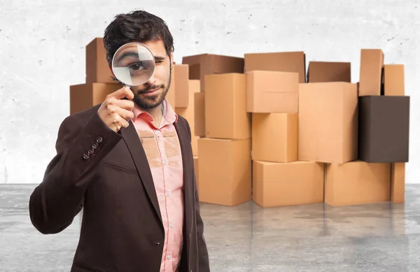 Happy businessman with magnifying glass — Stock Photo, Image