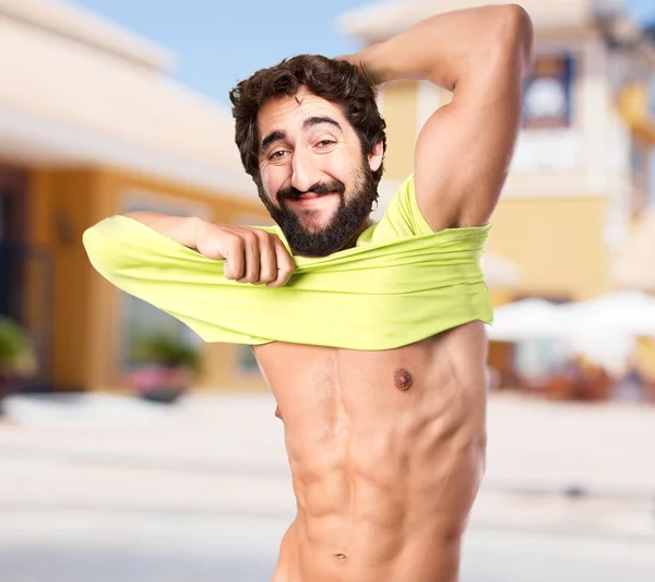 Happy young man in strong pose — Stock Photo, Image