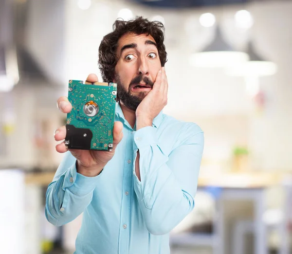 Surprised young man with hard drive — Stock Photo, Image