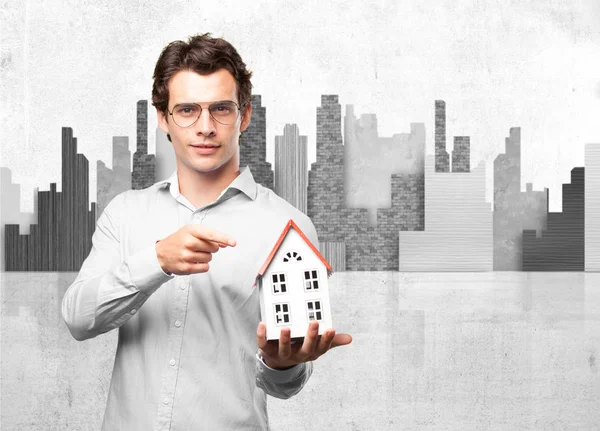 Happy young man with house model — Stock Photo, Image