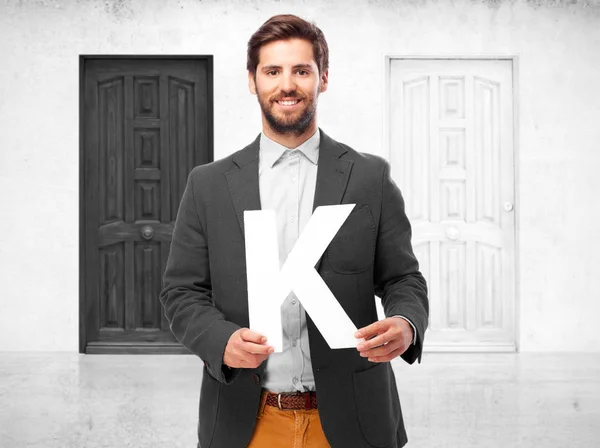 Homem de negócios feliz com a letra K — Fotografia de Stock