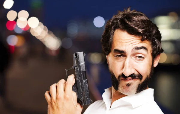 Young cool man with gun — Stock Photo, Image