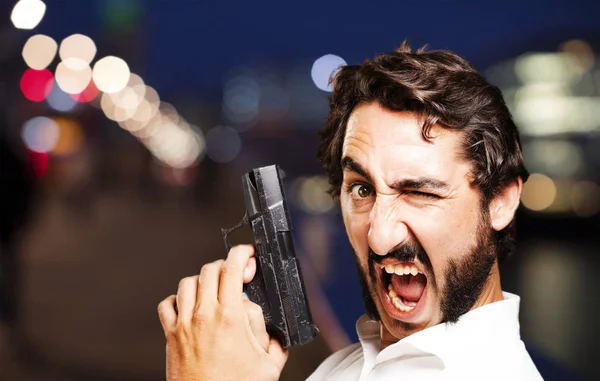 Young cool man with gun — Stock Photo, Image