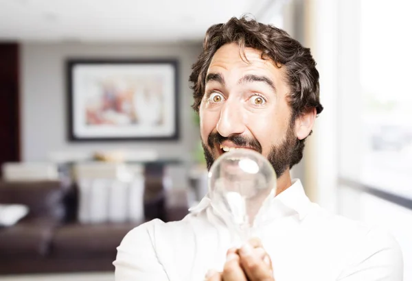 Young cool man with a lightbulb — Stock Photo, Image