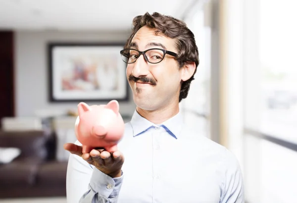 Young cool man with a piggy bank — Stock Photo, Image