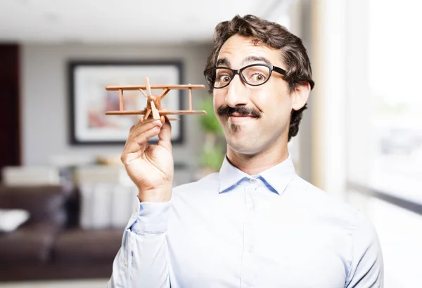 Young cool man with a wooden plane — Stock Photo, Image