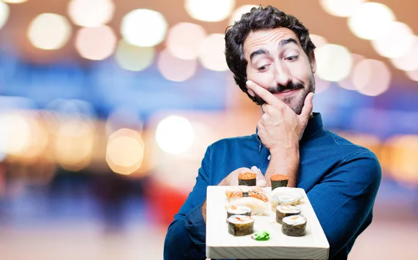 young man eating sushi