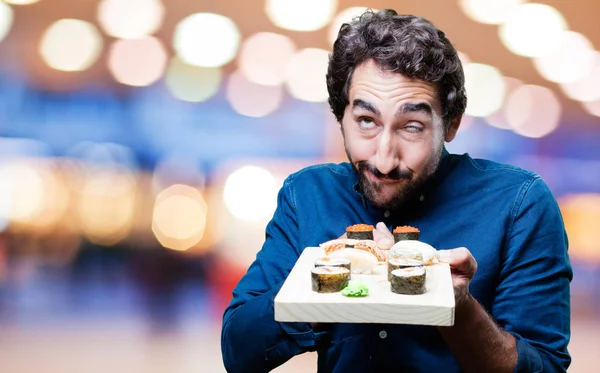 young man eating sushi