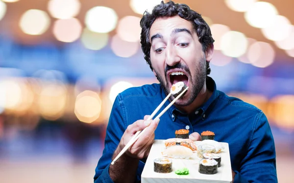 young man eating sushi