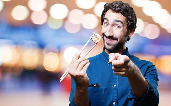 Homem comendo sushi e mostrando sinal — Fotografia de Stock