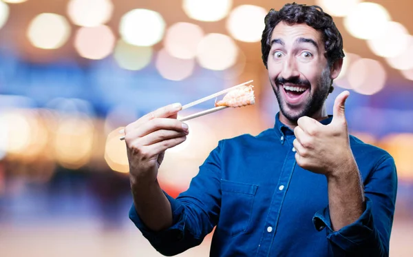 Homem comendo sushi com tudo bem sinal — Fotografia de Stock