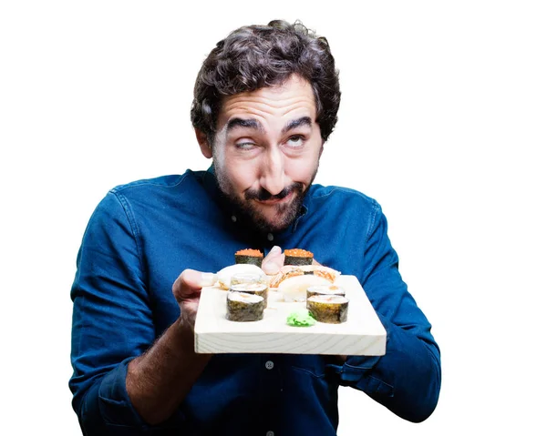 Junger Mann isst Sushi — Stockfoto