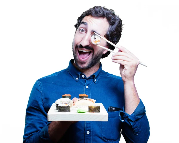 Молодой человек ест суши — стоковое фото