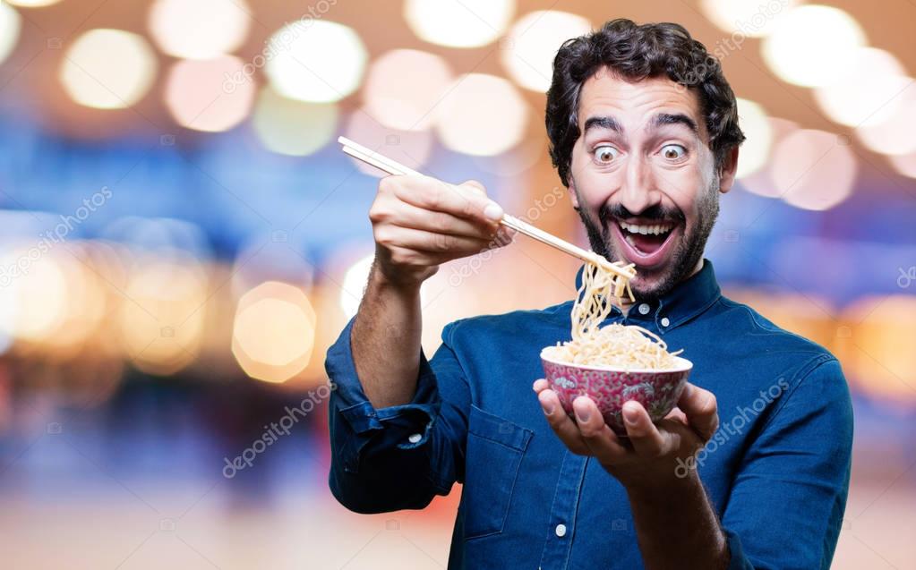 man eating sushi from noodles pot