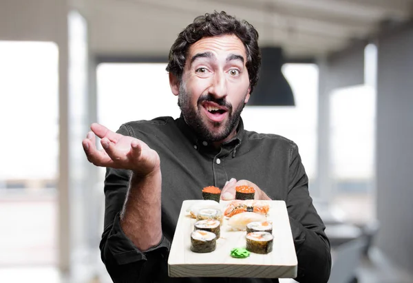 young man eating sushi