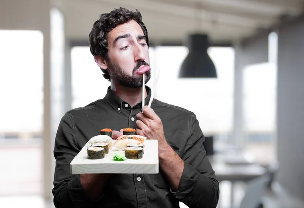 young man eating sushi