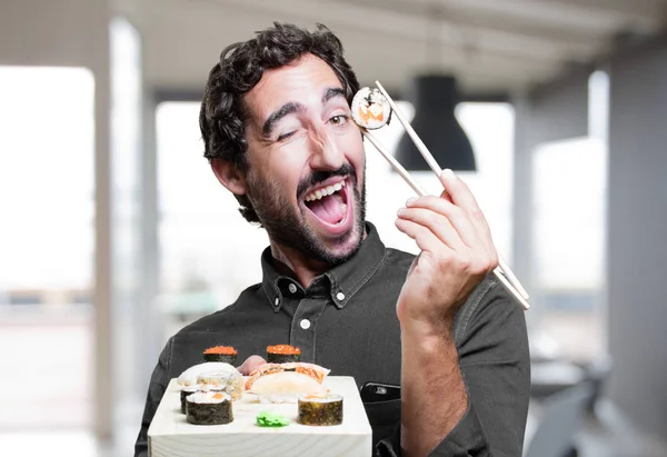 young man eating sushi