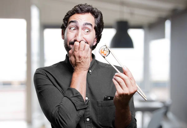 young man eating sushi