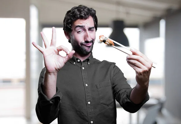 man eating sushi with all right sign